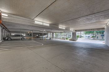 A parking garage with a concrete floor and walls.